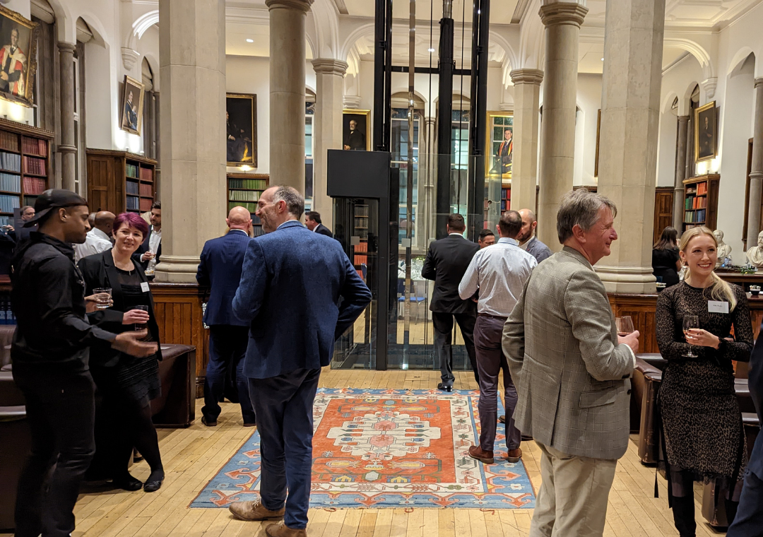 Lots of people in a grand old building in Manchester, coming together to discuss social change.